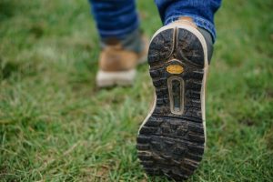 Person wearing hiking shoes during their solo hiking adventure